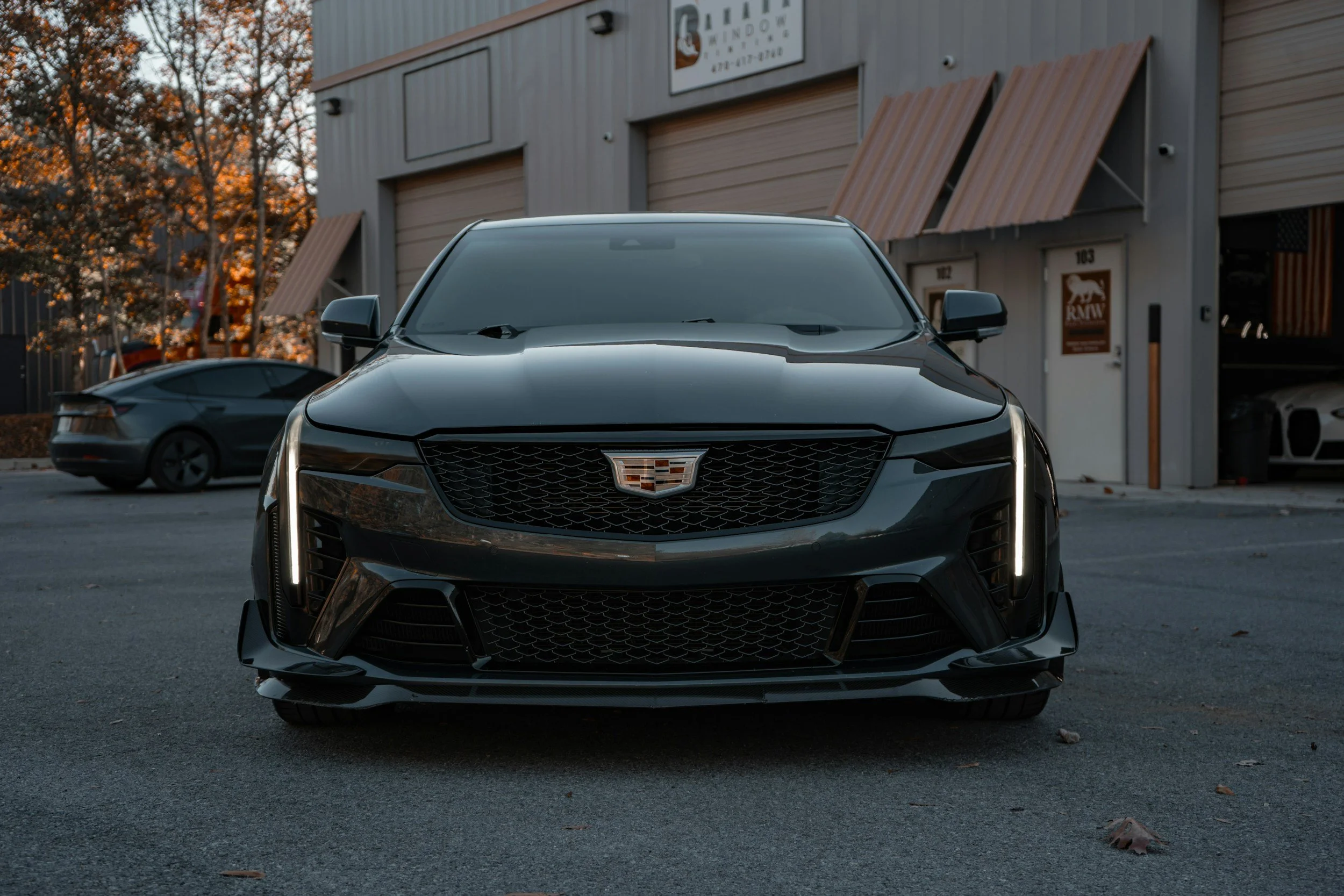 Front view of a dark Cadillac sedan parked outdoors in Denver, CO — luxury car ready for exterior detailing, mobile car wash, and paint protection services.